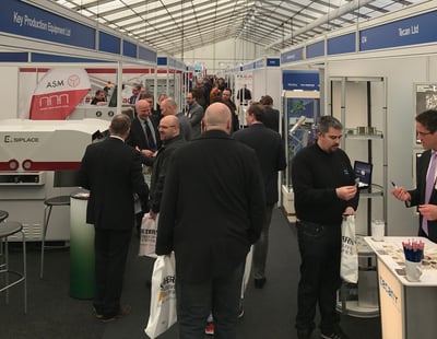 visitors attending an electronics and manufacturing exhibition