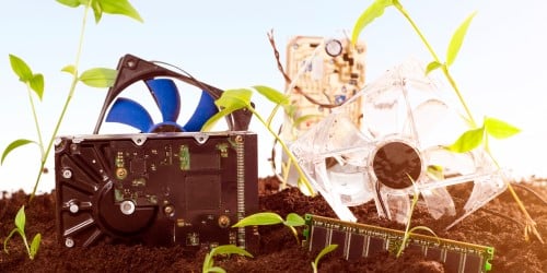 computer parts laying in soil